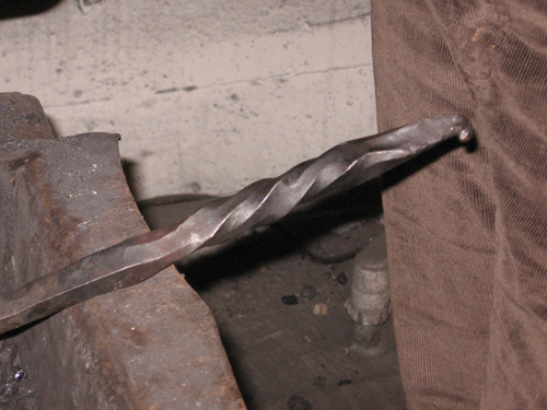 A square bar is hammered into an octagonal shape, twisted, and then hammered a bit more.
