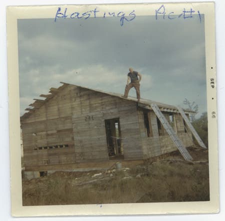 Photo of aluminum ladders against a house, for fatigue testing.