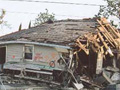 Photograph of a destroyed house.