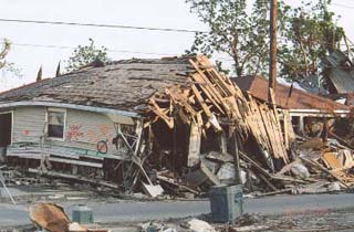 Photograph of a destroyed house.