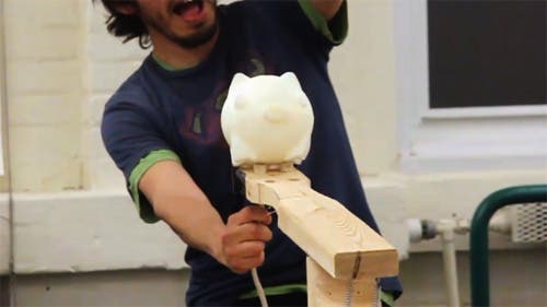 Student about to release catapult with a cast pig.
