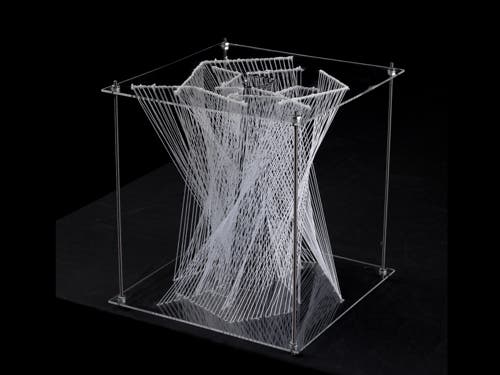 Photograph of thread model with thread mapping out connections between two acrylic plates.