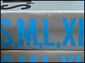 Stacks of books on a table, with the silver-covered books with blue lettering as the focal point.