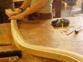 A wood-bending demonstration.  Three students bending wooden strips with their hands.