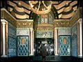 Arab Hall in the Leighton House Museum located in London shown with gold, blue and turquoise Islamic tile mosaics.