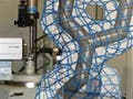 Molecular model of amino acid tyrosine overlaid on photograph of xray diffractometer.