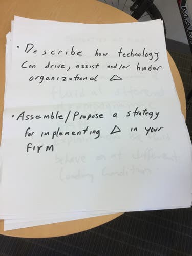 Sample learning outcomes written in magic marker on an oversized sheet of paper.