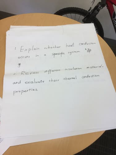 Sample learning outcomes written in magic marker on an oversized sheet of paper.