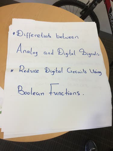 Sample learning outcomes written in magic marker on an oversized sheet of paper.