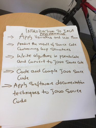 Sample learning outcomes written in magic marker on an oversized sheet of paper.