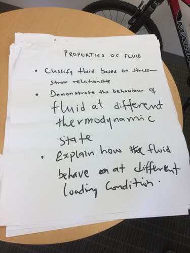 Sample learning outcomes written in magic marker on an oversized sheet of paper.