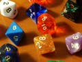 Dice of different shapes and colors.
