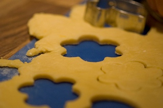 Photograph of a cookie cutter and cookie dough.