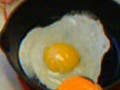 Photo of an egg frying in a pan.