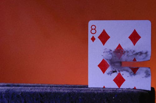 8 of diamonds with bullet halfway through the card.