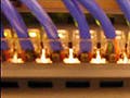 Photo of the back of a network switch, with multiple ethernet cables plugged in.
