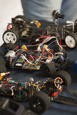Set of three small robotic cars showing interior and wiring. 