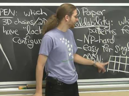 Professor in front of blackboard.