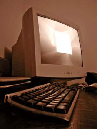 A sepia toned photograph of a personal computer.