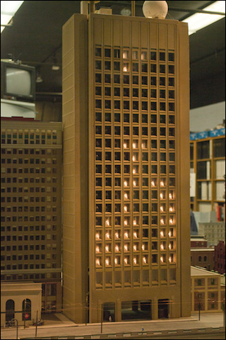 Photo of a model of the Green Building at MIT, illuminated with a version of a Tetris game.