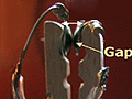 Wires and a clothespin arranged for an experiment.
