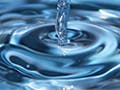 A water drop on top and water column with waves below it.