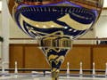 Photograph of a pendulum suspended from the ceiling over a circular base.
