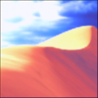 A blurry image of a sand dune and sky above.