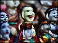 Photograph of small, brightly colored human-like figurines.