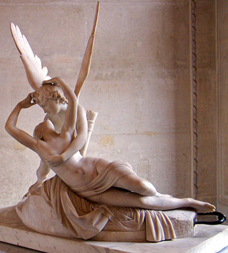 A marble statue of a winged gentleman embracing a reclining woman.