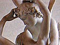 A marble statue of a winged gentleman embracing a reclining woman.