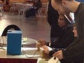 A photo of several people playing a version of Spacewar that was made by the MIT-Singapore GAMBIT Lab in honor of Spacewar's 50th anniversary.