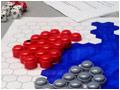 Colored pieces on a board of hexagons, many sided dice, and a sheet of rules.