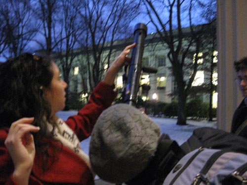 Photo of students viewing the moon through a small telescope.