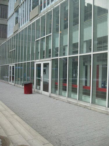Photo of another building with rectangular forms seen through the window.