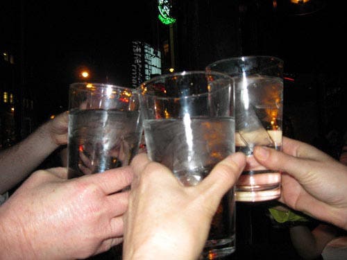 Photo of students raising their glasses in a toast to Galileo.