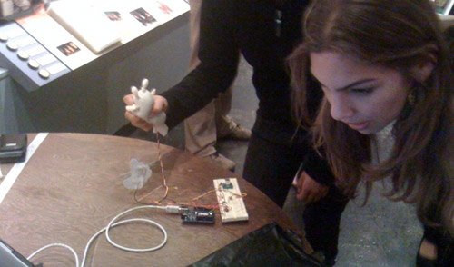 A photo showing an attendee squeezing the prototype, which was connected to a circuit board.