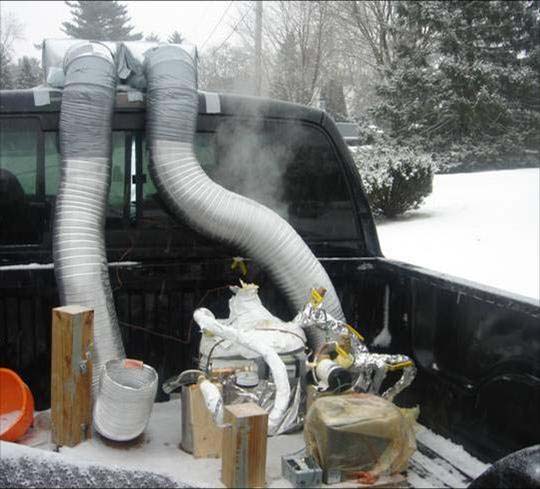 Image of a prototype device that utilized the waste heat from the exhaust of a civilian pick up truck in order to distill and purify water while the vehicle was idling or in use.