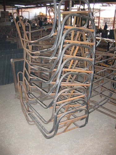 Photo of a stack of trike frames.