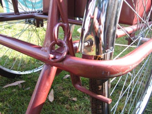 Photo showing brake lever attached to trike frame by a pair of s