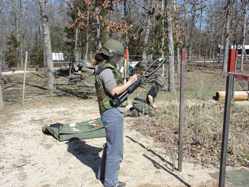 Student using metal detector. 