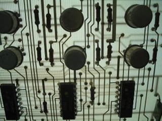 A photo of a backlit printed circuit board.