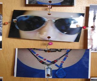 Photo of a person's face, sunglasses, shirt and necklaces.