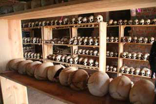 Skulls of Rwandan genocide victims, lined up on shelves.