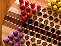 A star shaped board with different colored pegs in each corner.