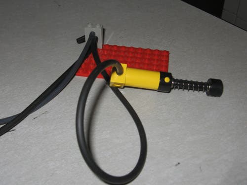 A standard Lego claw run by a pneumatic pump sensor.