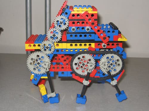A Lego robot with three pairs of legs.