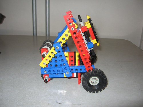 A triangular-framed robot, with wheels on two sides.