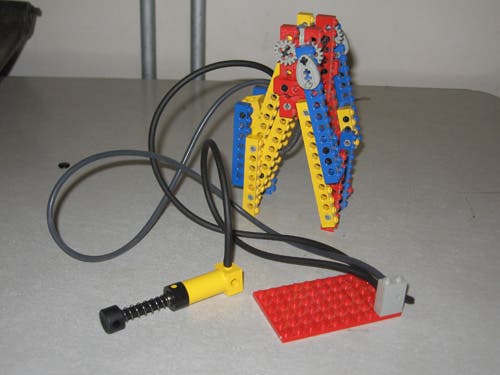 A standard Lego claw run by a pneumatic pump sensor.