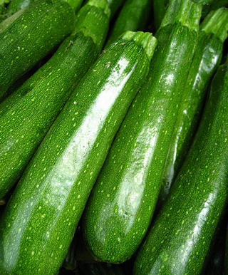 A photograph of half a dozen zucchinis.